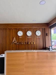 four clocks on a wall with ainders nine sign at Aero Inn in Nedumbassery