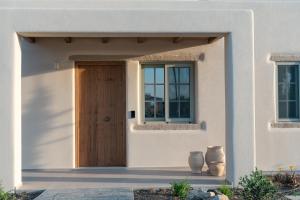 a house with a wooden door and windows at Elion Private Pool Villas in Kos
