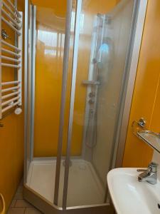 a shower in a bathroom next to a sink at Guesthouse Langafit in Laugarbakki