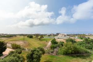 an aerial view of a park with trees and a building at Apto Oasis Playa & Golf Almerimar in Almerimar