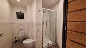 a bathroom with a toilet and a sink and a shower at Lucas House in Bibbona +22 photos