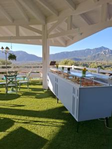 a white outdoor kitchen with a view of the mountains at Country House S'Ozzastru in Dorgali