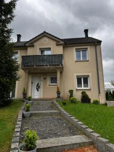 a house with a balcony on top of it at Zen House - Shopping at 3 min in Marnach