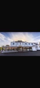 a large white building on the side of a street at Claremont Hotel in Alloa
