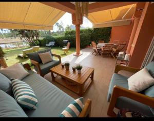 a living room with couches and a table and an umbrella at Villa comfort in Bouznika