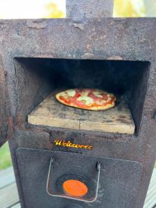 a pizza is cooking in a pizza oven at Sinne - Ecohuisjes Terschelling in Midsland