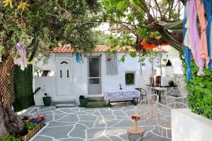 a patio with a tree and a bench in a yard at The Nest in Astris