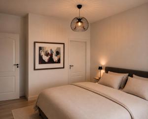 a bedroom with a bed and a picture on the wall at B&B Saint Pierre in Maastricht +8 photos