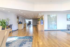 a large room with wooden floors and white walls and a lobby at La Quinta by Wyndham Sarasota Downtown in Sarasota +33 photos