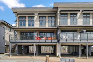 a building with a balcony with chairs on it at Saratoga Beach Villa 6 in Oyster Bay