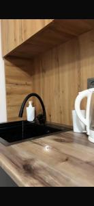 a kitchen counter with a sink and two cups on it at BonHome квартиры in Bulan Sogottuu +20 photos
