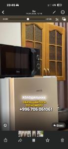a picture of a microwave on top of a box at BonHome квартиры in Bulan Sogottuu