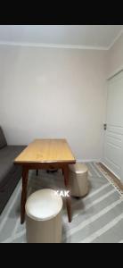 a small room with a wooden table and a stool at BonHome квартиры in Bulan Sogottuu