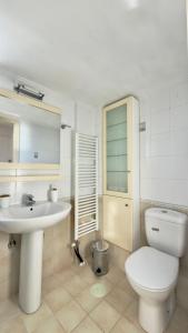 a bathroom with a white toilet and a sink at Lumaverde Estate in Kalamata +40 photos