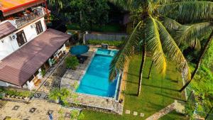 an overhead view of a swimming pool next to a house at Breezy River in Kalutara