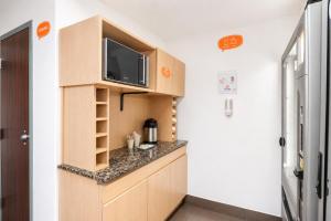 a kitchen with a tv on top of a cabinet at Hotel Hi! Queretaro in Querétaro