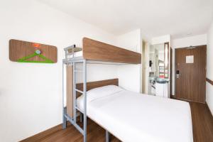 a small bedroom with a bunk bed and a ladder at Hotel Hi! Queretaro in Querétaro