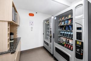 a refrigerator filled with lots of drinks in a kitchen at Hotel Hi! Queretaro in Querétaro