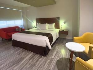 a hotel room with a large bed and a couch at Hotel Inclan in Lima
