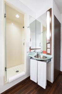 a bathroom with a sink and a shower at Hotel Hi! Queretaro in Querétaro +17 photos