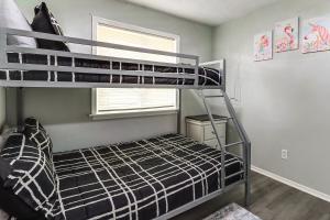 a bedroom with a bunk bed and a window at Lake Access & Game Room! Poconos Resort Getaway in Tobyhanna +31 photos