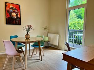 a dining room with a table and chairs and a window at Apartments am Burgberg in Bad Harzburg
