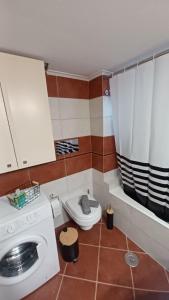 a bathroom with a washing machine and a toilet at P&M House in Agrinio +13 photos