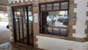 a building with two windows on the side of it at P&M House in Agrinio