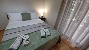 a bedroom with a large bed with towels on it at P&M House in Agrinio