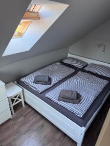 a bed with two pillows on it in a room at Wohlfuehl-Orte24 am Hafen in Schaprode, Rügen in Schaprode
