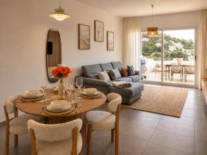a living room with a table and a couch at Altea Sol Marina Apartment by NRAS in Altea