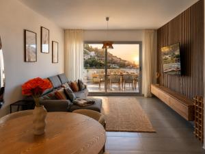 a living room with a couch and a table at Altea Sol Marina Apartment by NRAS in Altea