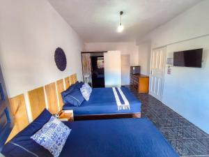 a hotel room with two beds and a television at Pousada Mar de Itacaré in Itacaré +29 photos