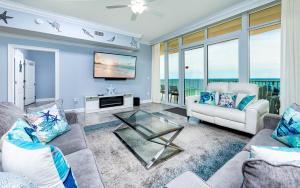 a living room with two couches and a tv at Phoenix Gulf Towers 805 condo in Gulf Shores