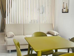 a living room with a couch and a table at Case Vacanza il Sole in La Maddalena +14 photos