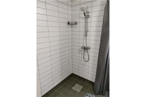 a bathroom with a shower with white tiles at Lofotenfeeling, Haverringen Panorama in Vestvågøya +34 photos