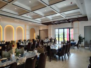 a banquet hall with tables and chairs in a room at The Holy Awadh Hotel in Ayodhya