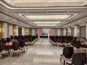 a row of chairs in a room with a stage at The Holy Awadh Hotel in Ayodhya