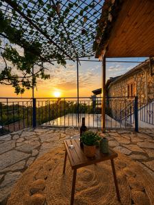 a table with a plant on top of a patio at Belle Elle Villa in Drymon