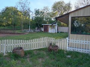 a white picket fence in front of a house at Etno Han crvena reka in Bela Palanka +4 photos