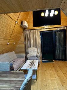 a living room with a couch and a table at cottages house in Namlisevi