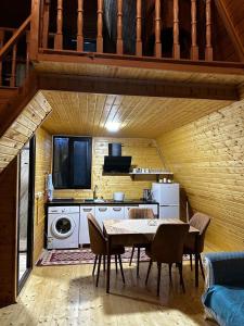 a kitchen and dining room with a table and chairs at cottages house in Namlisevi