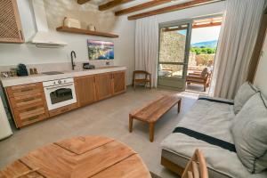 a kitchen and living room with a couch and a table at Elion Private Pool Villas in Kos +35 photos