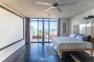 a bedroom with a bed and a ceiling fan at Puerto del Cielo in Chuburná +65 photos