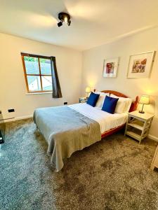 a bedroom with a large bed and a window at Dolphin Bay Suites in Ardersier