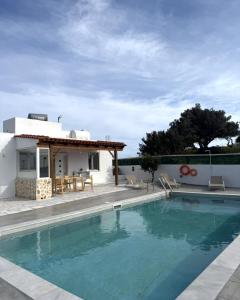 a villa with a swimming pool and a house at Villa George Sea View with pool - Triopetra in Triopetra