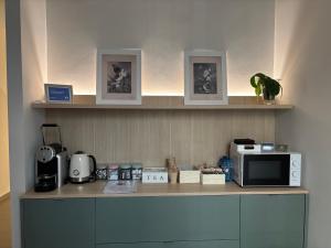 a kitchen with a counter with a microwave and appliances at Art Experience B&B "Hotel Boutique" in Vinarós