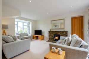 a living room with two couches and a fireplace at 3 Bed in Georgeham oc-halcy in Georgeham