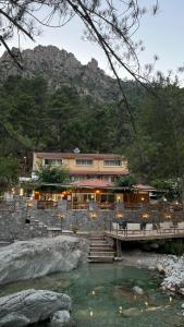 a building with a bridge over a body of water at Hotel Arena le Refuge in Corte
