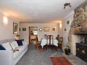 a living room with a couch and a table and a fireplace at 4 Bed in Bishop Auckland oc-93527 in Wear Head
